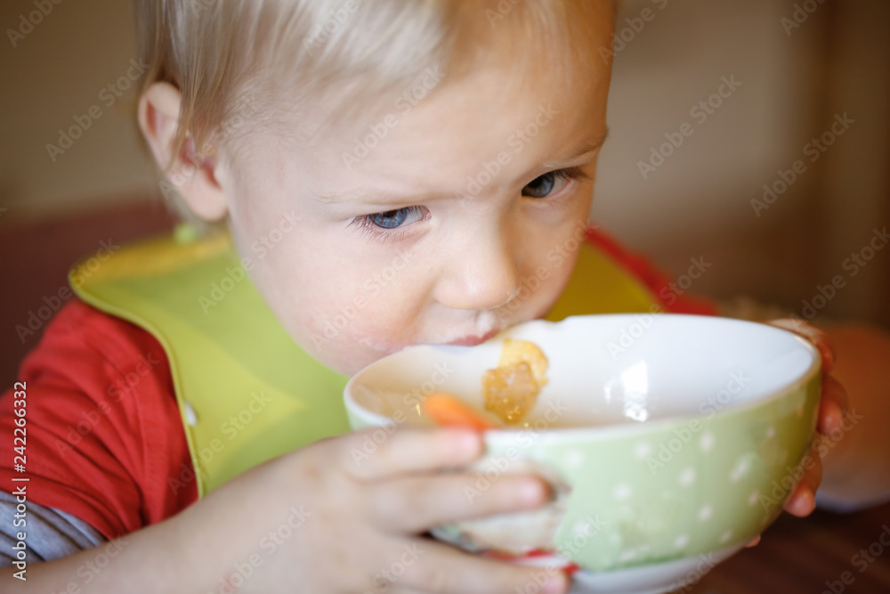 Little boy drinking independently from a bowl Little boy drinking independently from a bowl