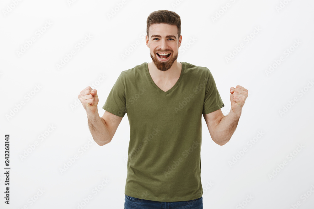 Come on you can do it. Active and excited happy handsome man with beard clench fists in cheer, being supportive encouraging friend, watching team scoring goal, celebrating victory, triumphing Come on you can do it. Active and excited happy handsome man with beard clench fists in cheer, being supportive encouraging friend, watching team scoring goal, celebrating victory, triumphing