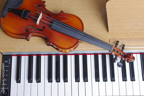 Keyboard piano and violin. Close-up
