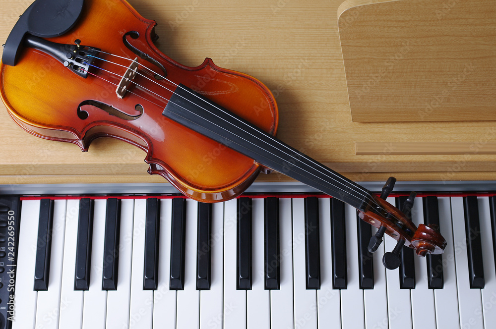 Keyboard piano and violin. Close-up