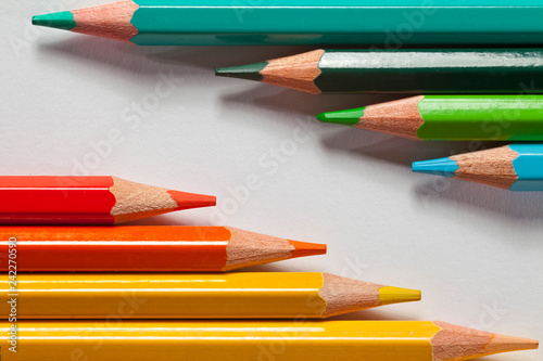 yellow, red, green and blue crayons on white background
