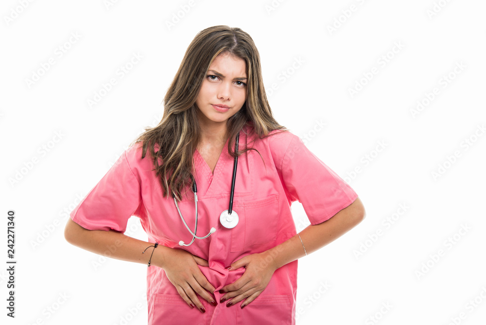 Portrait of beautiful young doctor holding belly like hurting Portrait of beautiful young doctor holding belly like hurting