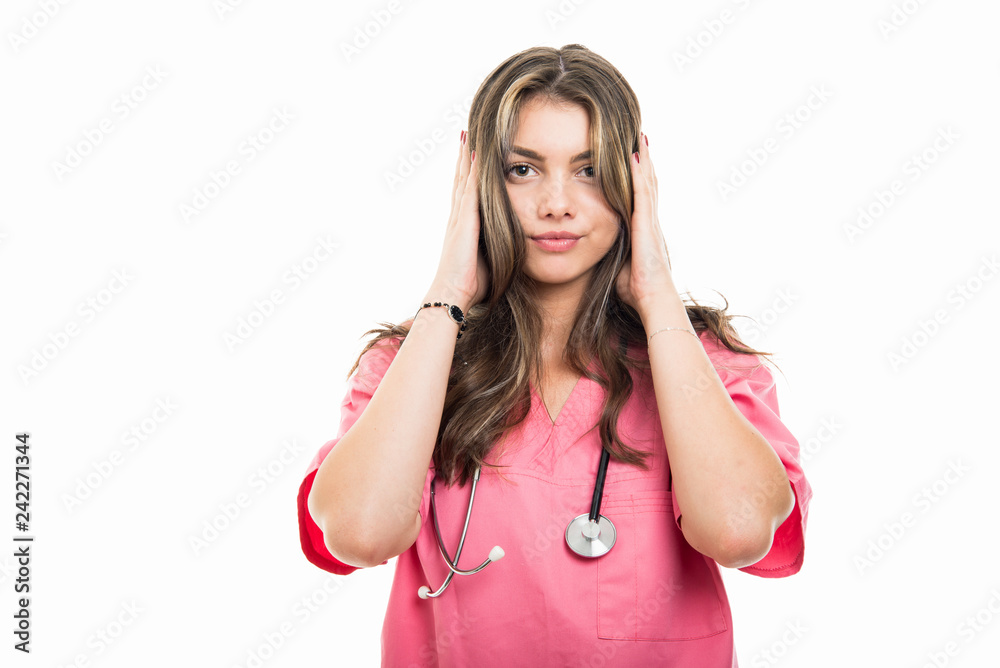 Portrait of beautiful young doctor covering ears like deaf concept Portrait of beautiful young doctor covering ears like deaf concept