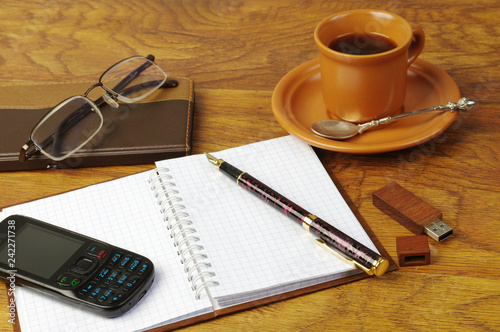 Cup of coffee, fountain pen, flashcard, notebook and glasses