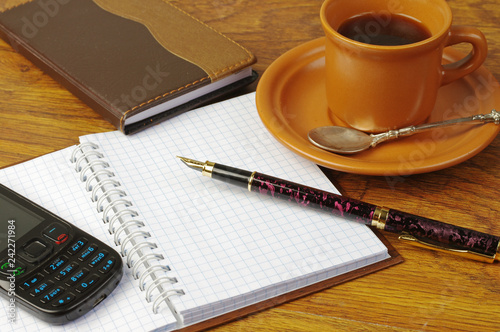 Cup of coffee, fountain pen, flashcard, notebook and glasses