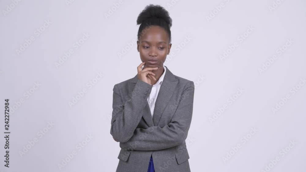 Young serious African businesswoman thinking and looking down Young serious African businesswoman thinking and looking down