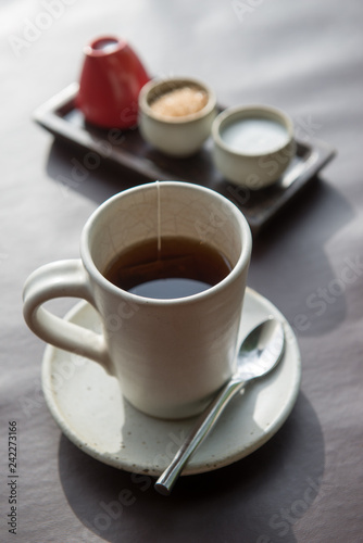 Fototapeta Naklejka Na Ścianę i Meble -  Hot tea served in a mug with milk and sugar