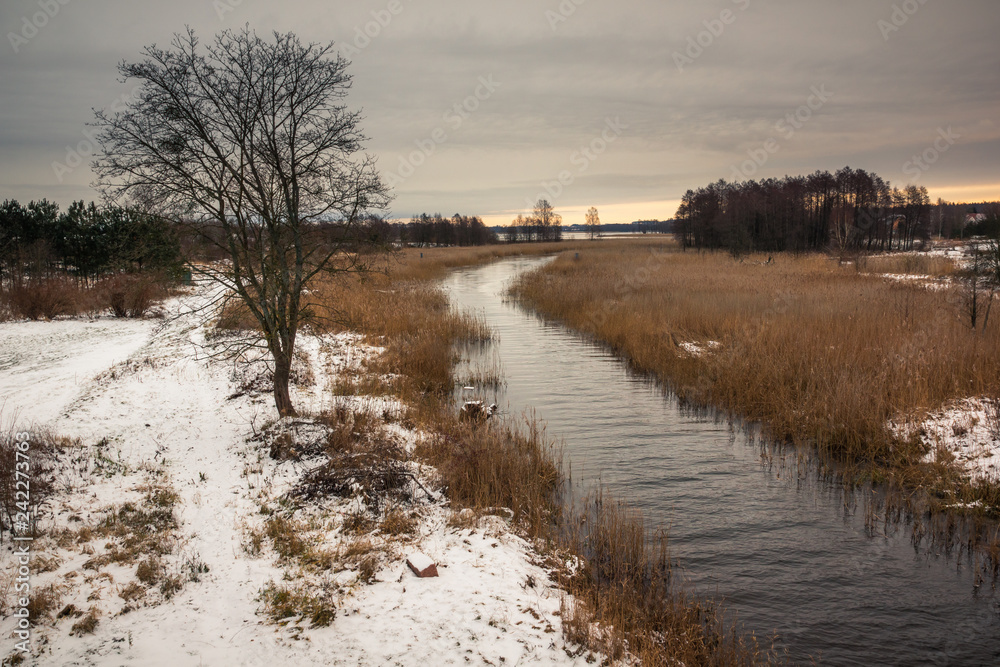 Sapina river at winter near Wegorzewo, Masuria, Poland