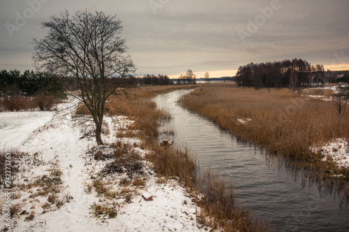 Sapina river at winter near Wegorzewo, Masuria, Poland photo