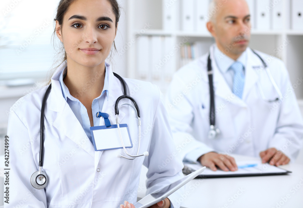 Portrait of young doctor woman in hospital. Hispanic or latin american staff in medicine. Patient service concept Portrait of young doctor woman in hospital. Hispanic or latin american staff in medicine. Patient service concept