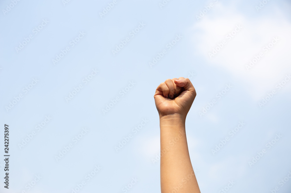 Woman arm with fist raised in the air. Woman arm with fist raised in the air.