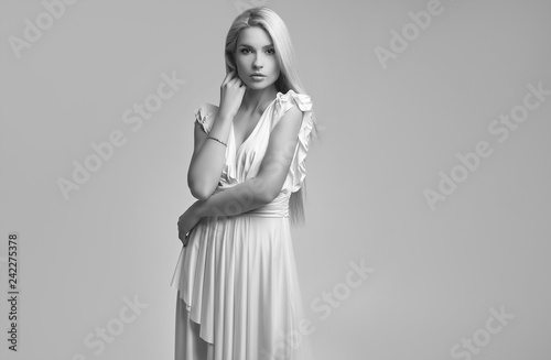 Gorgeous sensual blonde woman in fashion antique white dress