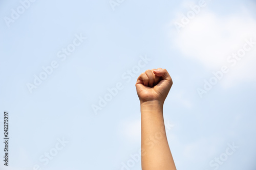 Woman arm with fist raised in the air.