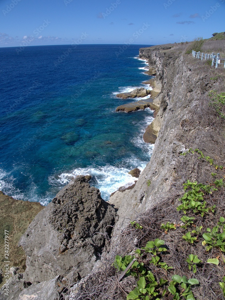 Scenic coastal view along high cliffs, with clear waters in a tropical island
