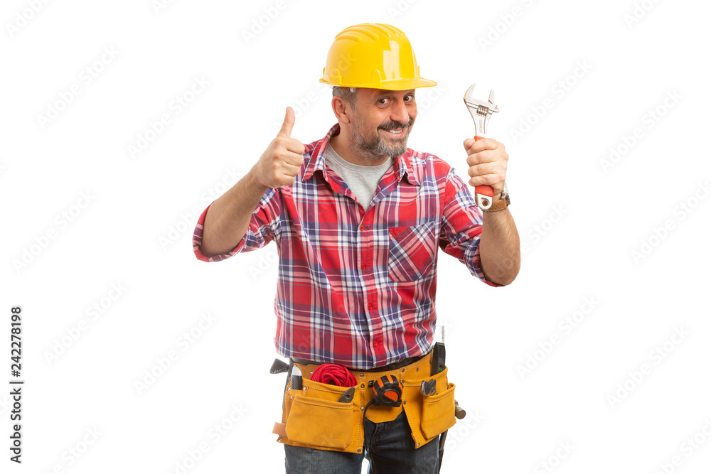 Builder holding wrench and thumb up. Builder holding wrench and thumb up.