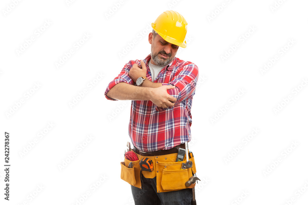 Construction worker looking at elbow. Construction worker looking at elbow.