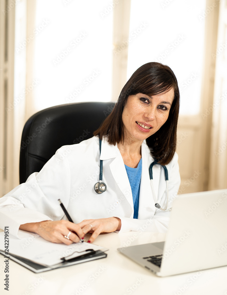 Female doctor working on medical expertise and searching information on laptop at hospital office Female doctor working on medical expertise and searching information on laptop at hospital office