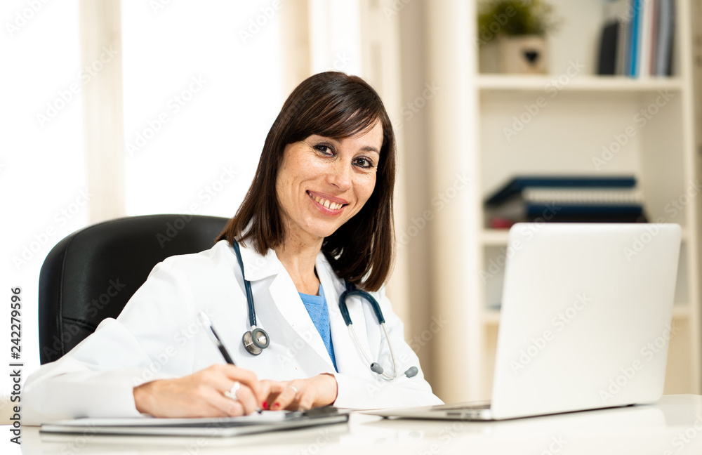 Female doctor working on medical expertise and searching information on laptop at hospital office Female doctor working on medical expertise and searching information on laptop at hospital office