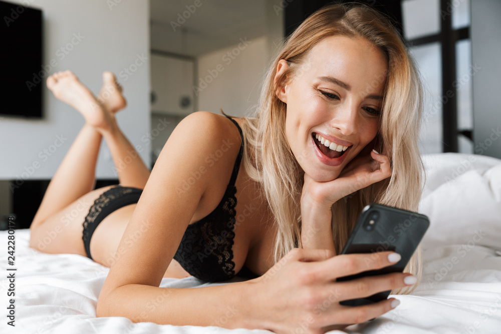 Beautiful smiling young woman wearing lingerie laying Beautiful smiling young woman wearing lingerie laying