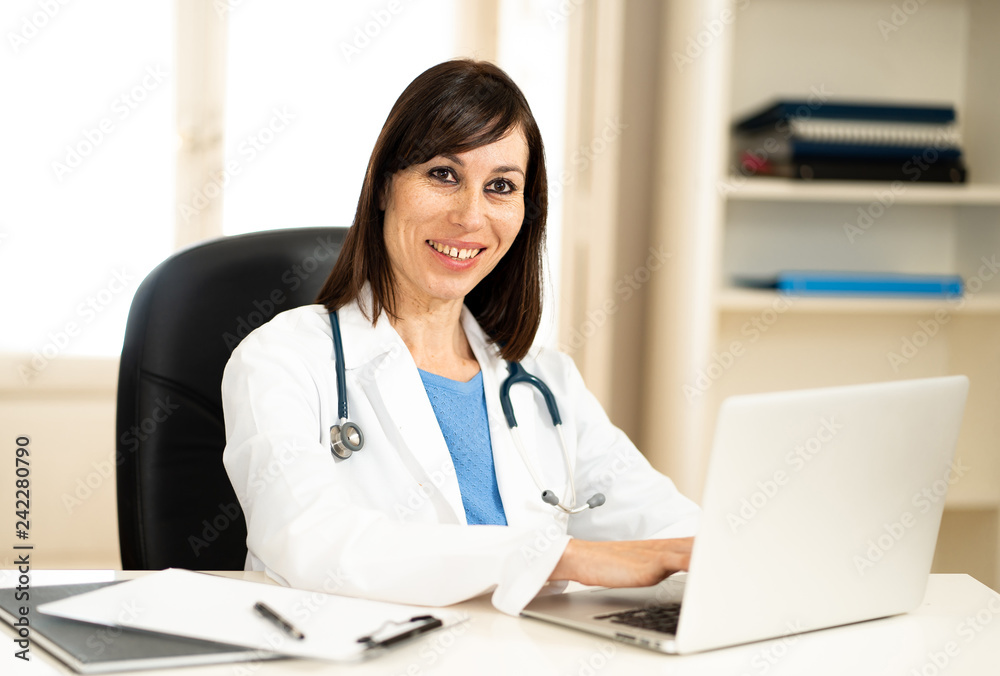 Female doctor working on medical expertise and searching information on laptop at hospital office Female doctor working on medical expertise and searching information on laptop at hospital office