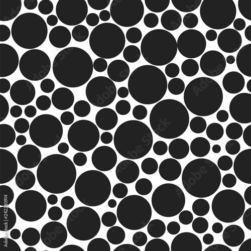 Black circles of various sizes on a white background. Seamless vector pattern.