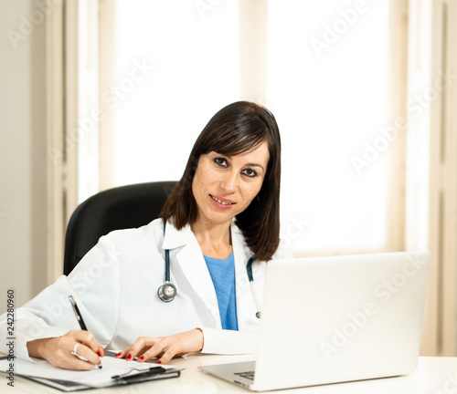 Successful female doctor working in clinic hospital office smiling and posing for the camera