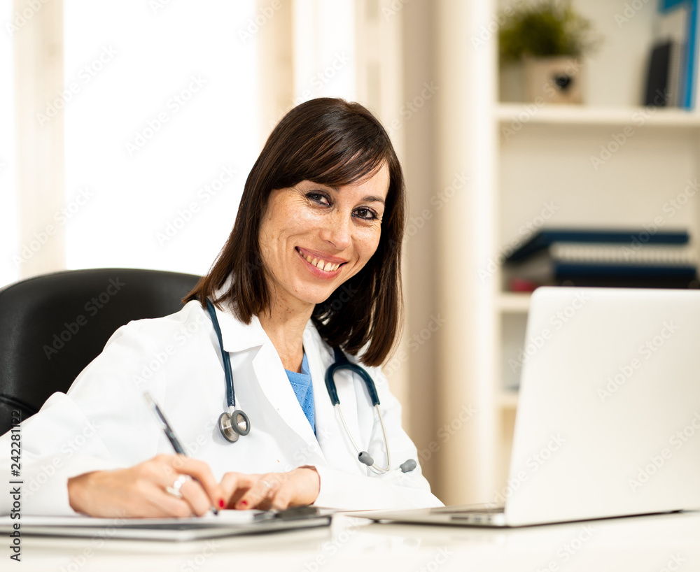 Female doctor working on medical expertise and searching information on laptop at hospital office Female doctor working on medical expertise and searching information on laptop at hospital office