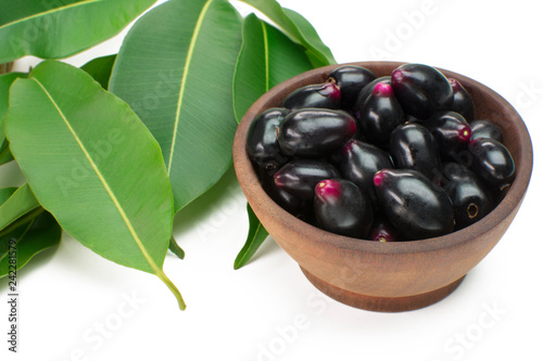 Exotic fruit Syzygium cumini called in Brazil as jamelão in wood bowl background photo