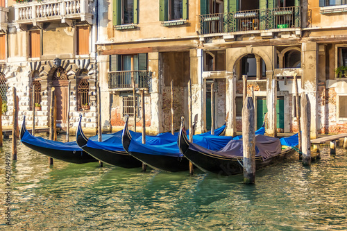 Venice palace with gondolas moored, Grand Canal, Italy