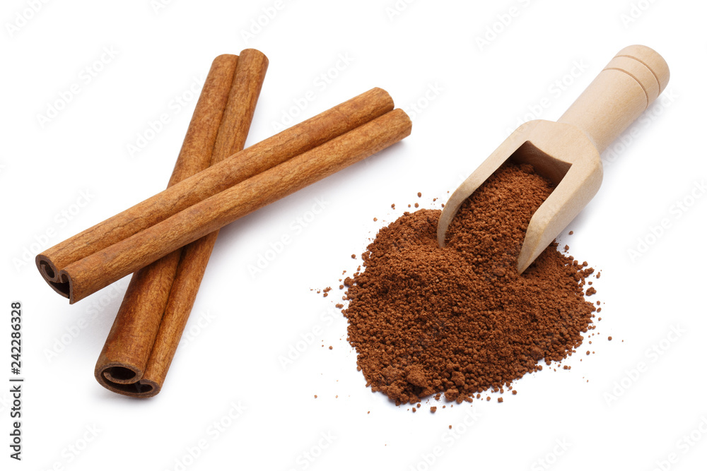 Cinnamon powder in a wooden scoop and cinnamon sticks, isolated on white background Cinnamon powder in a wooden scoop and cinnamon sticks, isolated on white background