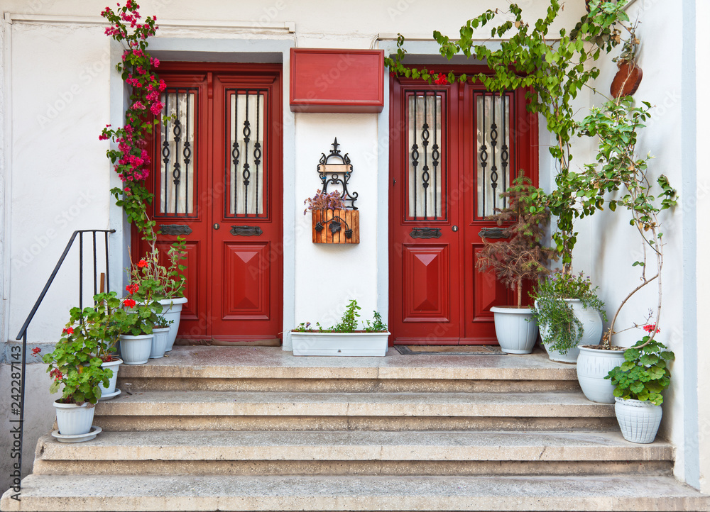 Naklejka premium Beautiful twin red door with flower