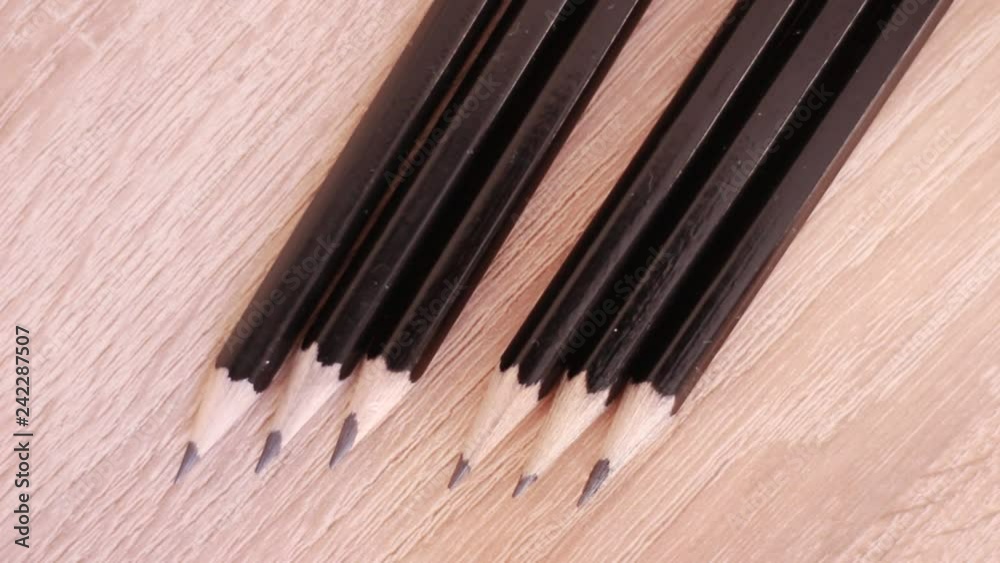 Single red pencil in range of black ones