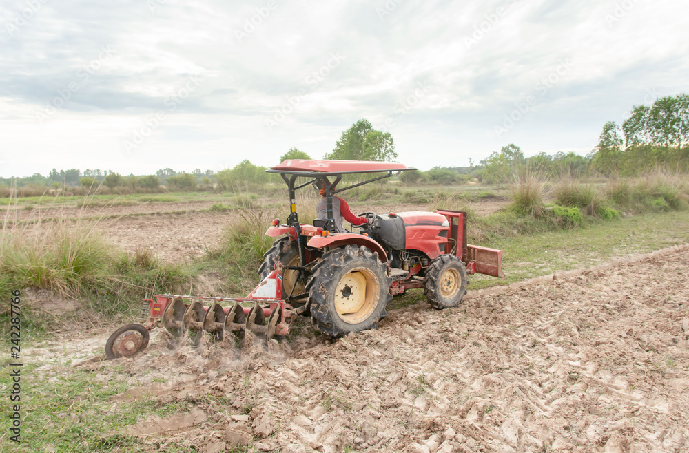 Tractor working plows a field on the farm for planting Tractor working plows a field on the farm for planting