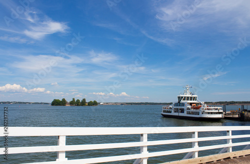 The passenger ferry transports tourists and residents to the island of Suomenlinna from Helsinki in Finland on a sunny summer day.