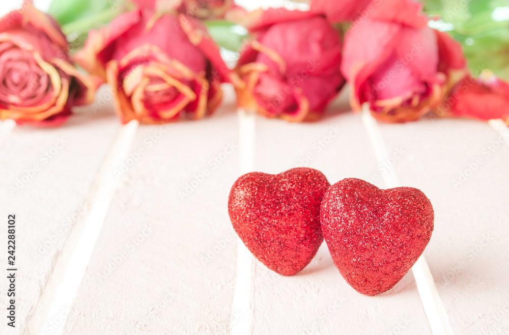 Fototapeta premium Two red hearts and rose on white wood background.