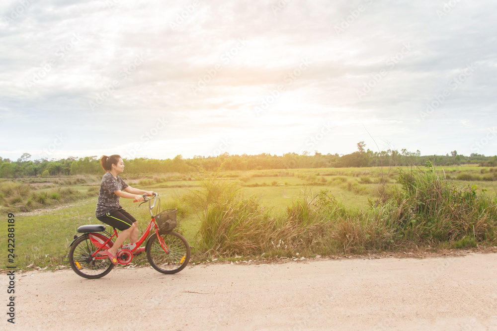 Woman riding bicycle relax in a country road. Woman riding bicycle relax in a country road.