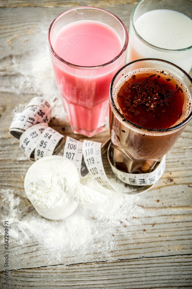 Healthy organic diet drink. Chocolate, berry and vanilla protein shakes. Non dairy protein vegan cocktails. With measuring tape. Concept of weight loss, fitness, healthy lifestyle. Healthy organic diet drink. Chocolate, berry and vanilla protein shakes. Non dairy protein vegan cocktails. With measuring tape. Concept of weight loss, fitness, healthy lifestyle.
