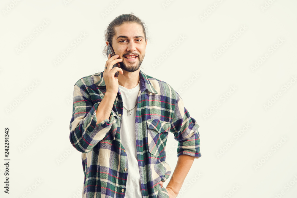 Cheerful man talking on a cell phone.