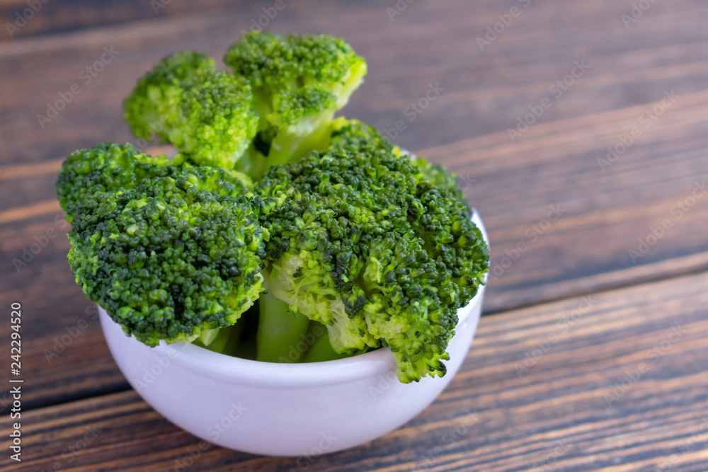 Bowl of cooked green broccoli.