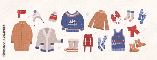 Bundle of knitted winter clothes and outerwear isolated on light background - woolen sweater, cardigan, waistcoat, snow boots, hat, gloves, socks. Set of seasonal clothing. Flat vector illustration. photo