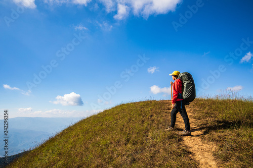 Young backpacking woman hiking on mountains. Doi Mon Chong, Chiangmai, Thailand.