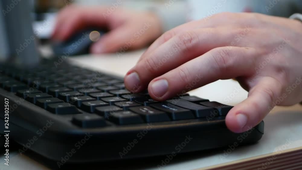 Male fingers are typing on the keyboard Male fingers are typing on the keyboard