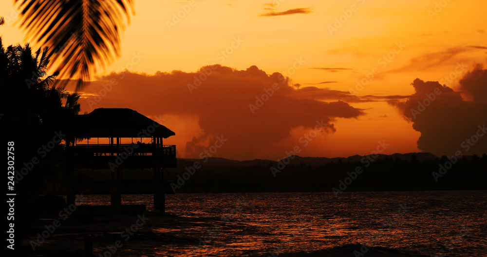 bungalow and silhouettes with Sunset, Philippines