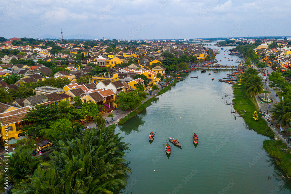 Tourists discover Hoi An town on the traditional boats on Thu Bon river