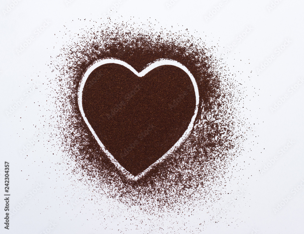 Heart on a white background laid out of ground coffee, close-up