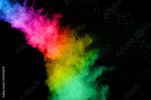 Abstract color powder explosion on black background.Freeze motion of dust splash. Painted Holi in festival.