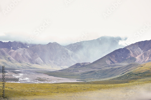 Dry River Bed Running Through Valley Between Mountains In Alaska © Monkey Business