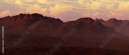 Sandy mountains with cloudy sky at sunset.