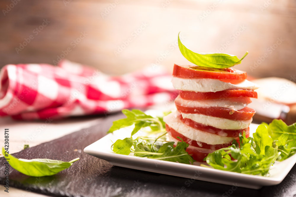 Tomato and Mozzarella slices with basil leaves
