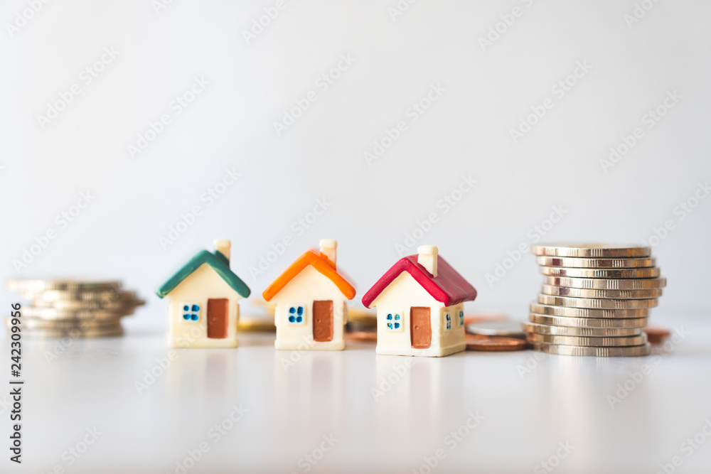 Miniature house with stack coins using as property and business concept